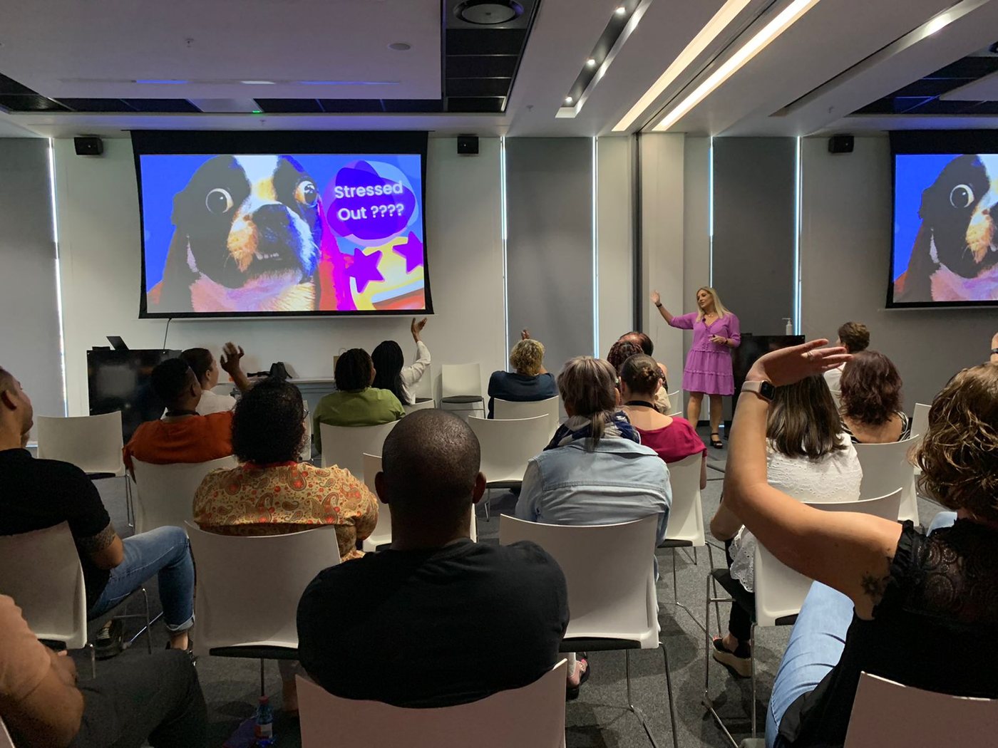 A corporate audience engaged in a team-building and stress-management session